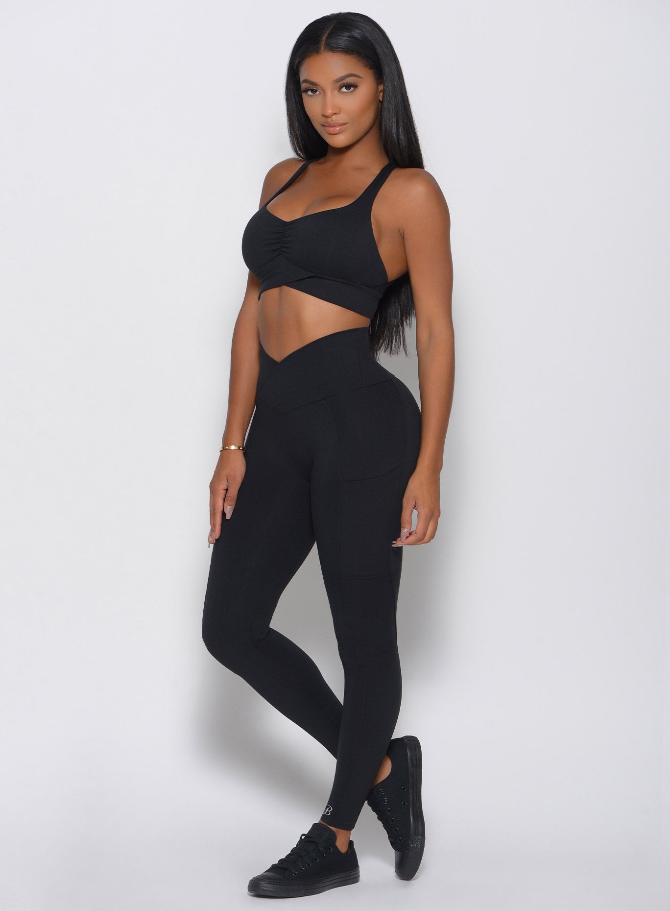 model in black contour leggings facing left arms at side