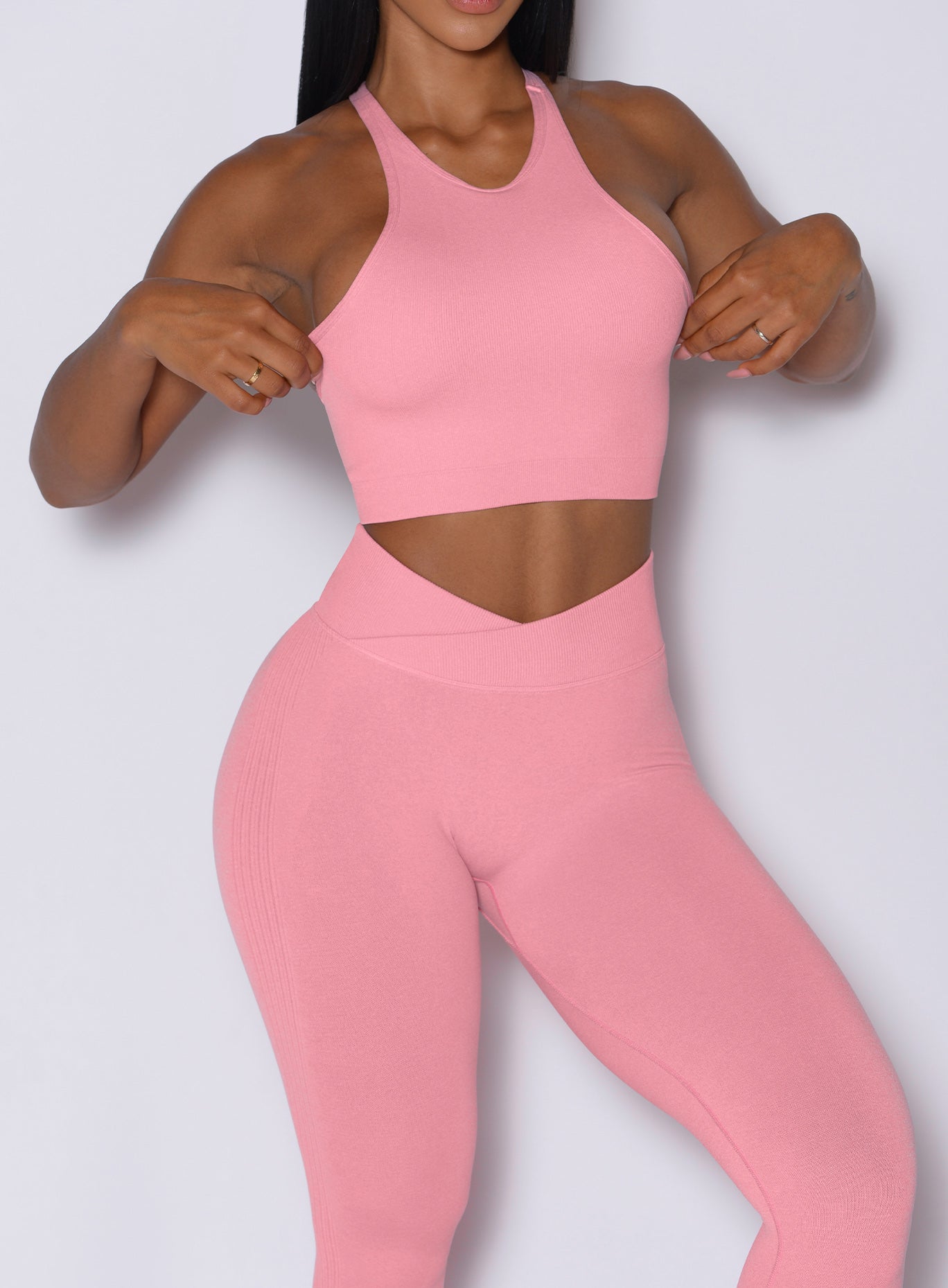 close up front profile view of a model in our Contour Seamless Leggings and the matching Lifter Heather Seamless Bra in Ballerina color