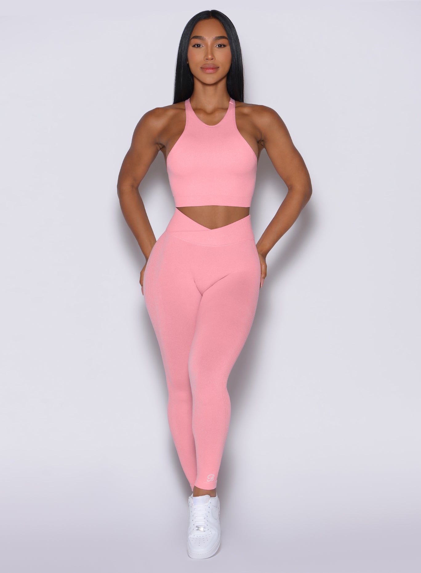 front profile view of a model wearing our Contour Seamless Leggings and the matching Lifter Heather Seamless Bra in Ballerina color